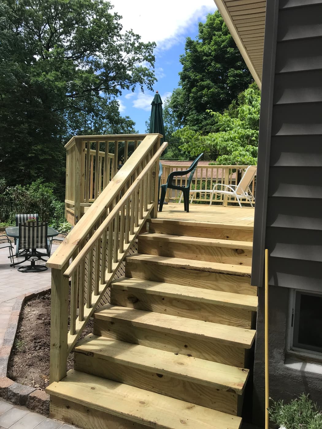 Pressure-treated deck and pergola framing during a build