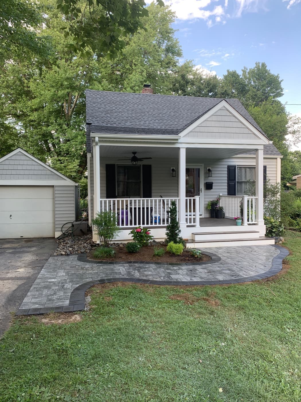 Paver walkway and patio leading up to a covered porch