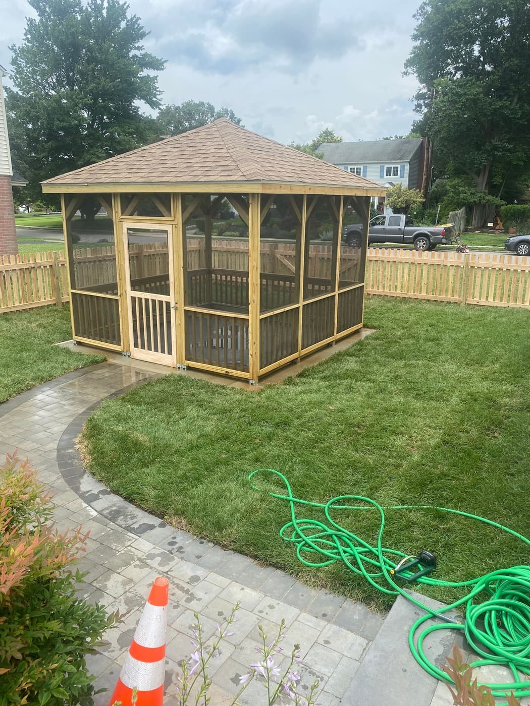 Finished cedar gazebo with a new sod lawn and paver walkway